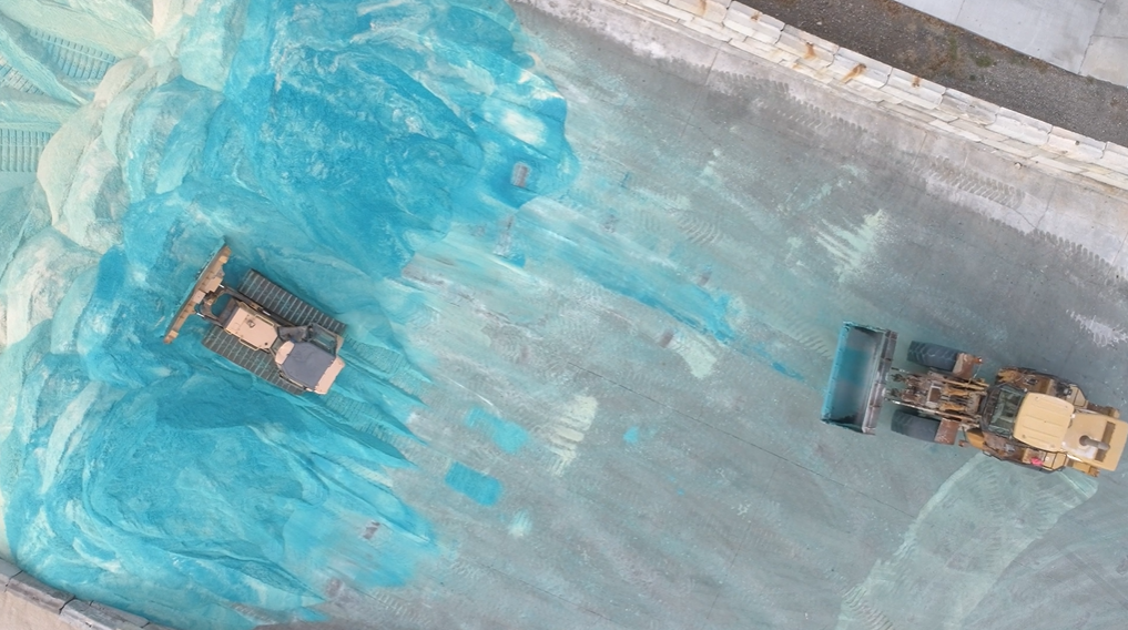 Vehicles processing treated salt at a Silvi Materials' facility.