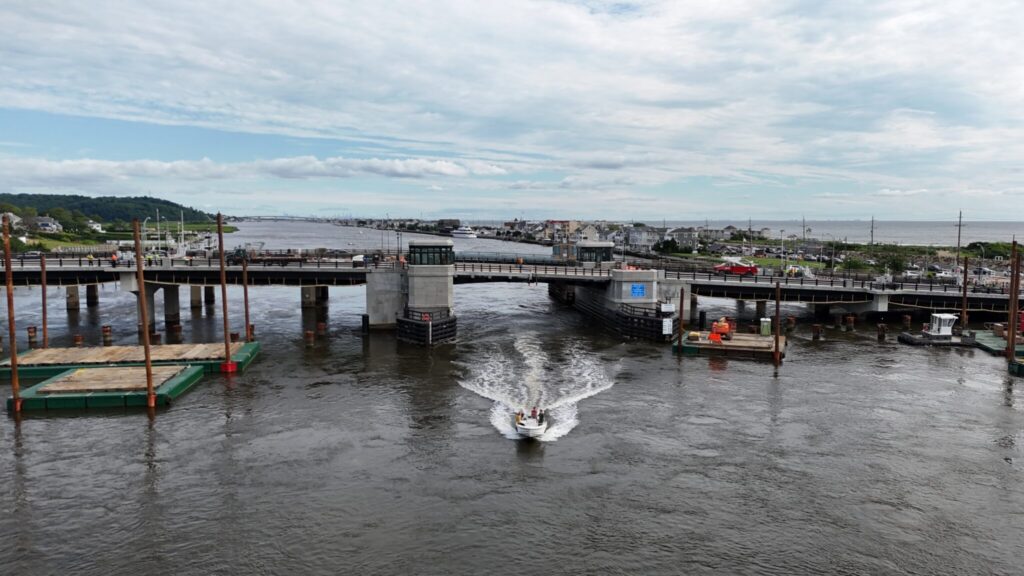 A photo of a boat passing under the Rumson-Sea Bright Bridge in Sea Bright, New Jersey.