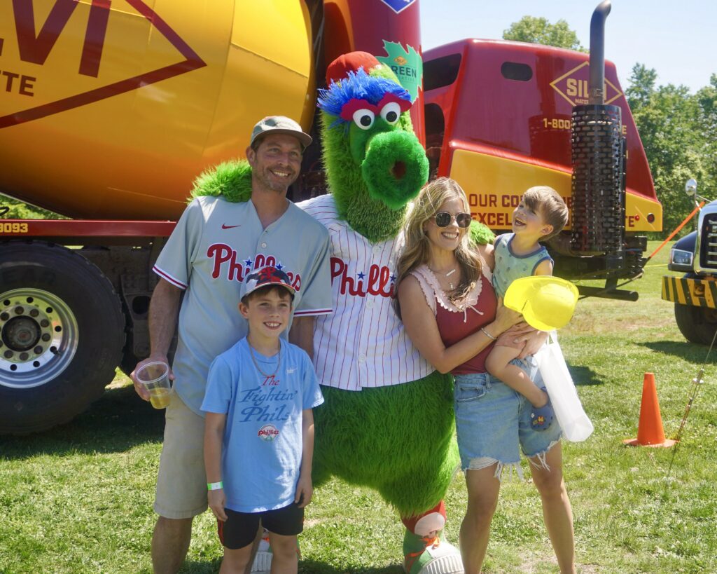 A picture of the Phillie Phanatic and attendees at the inaugural Silvi Foundation Touch-a-Truck.