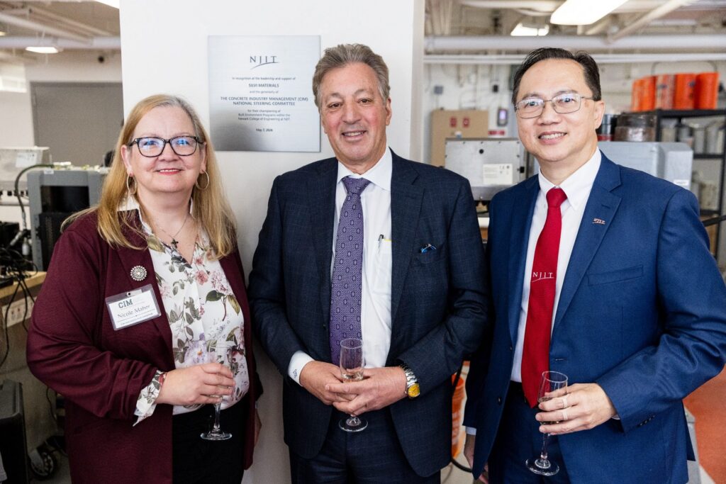Nicole Maher, Larry Silvi II, and NJIT President Dr. Teik C. Lim stand beside the dedication plaque for The Silvi Materials Concrete Lab.