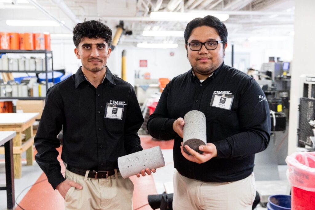 Students in The Silvi Materials Concrete Lab at NJIT holding concrete test cylinders during hands-on Concrete Industry Management coursework.